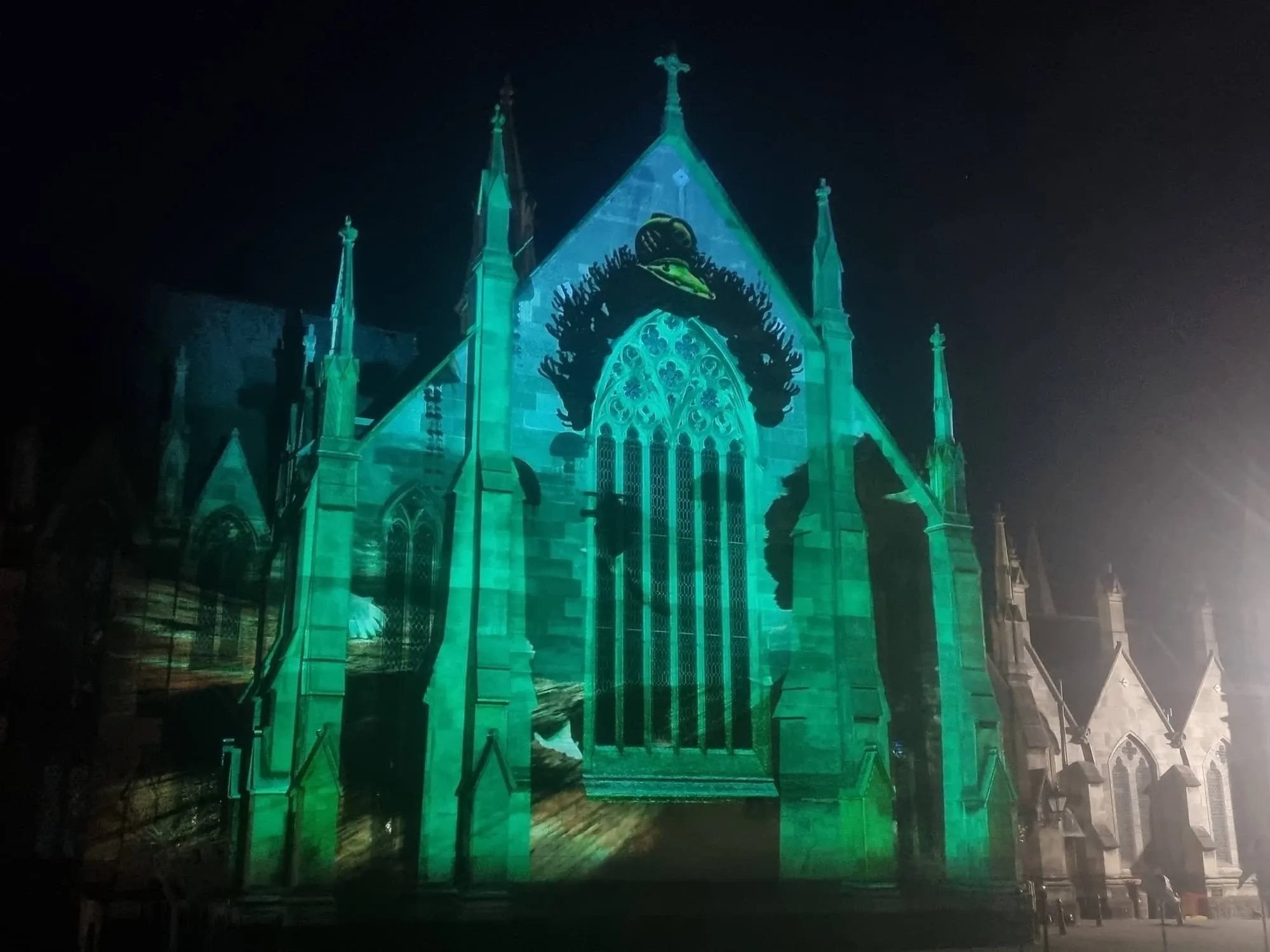 Projections on church wall at night